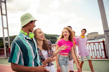 Buddies bonding outdoors on a sunny day, enjoying leisure and celebrating their friendship