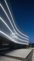 Modern Building with Curved Glass Facade and LED Lighting at Night