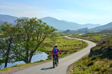 nice senior woman riding her electric mountain bike  in the highlands of Glen Affric Nature...