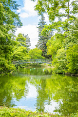 Iron footbridge and body of water of the Jardin Public, the public garden of Bordeaux, France