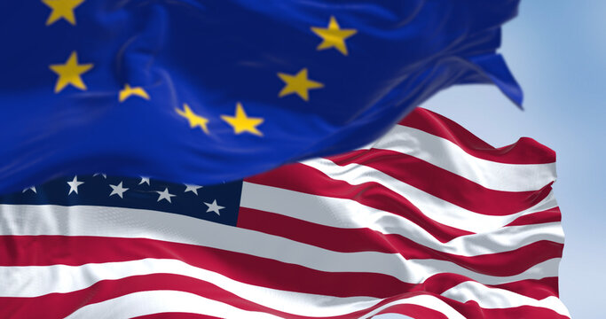 Flags of the United States of America and the European Union waving in the wind
