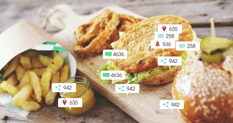 Displaying breaded chicken sandwiches with lettuce on wooden table, showing floating social icons
