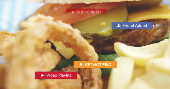 Featuring cheeseburger melting cheese at diner, pickles, tomato, onion rings, fries and UI banners - Powered by Adobe