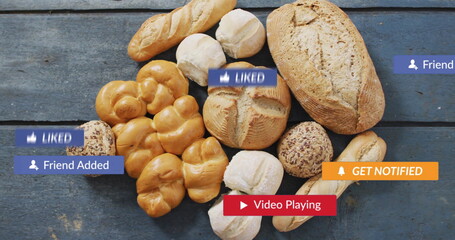 Displaying baked bread loaves over rustic blue wood table, with social media notification graphics