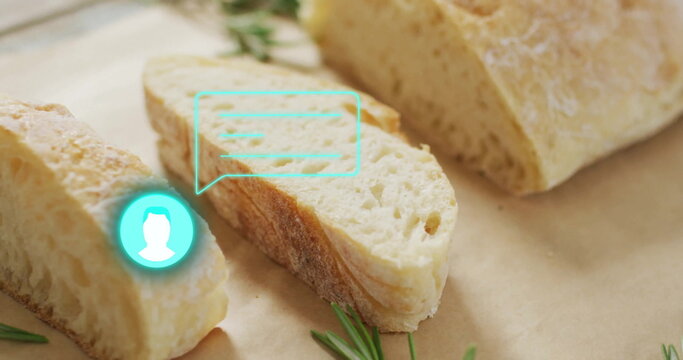 Fototapeta Displaying crusty bread slice on parchment on wooden countertop, with rosemary and turquoise icon