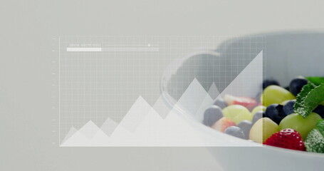 Showing bowl with grapes, blueberries, strawberries and mint on table with grid overlay, copy space