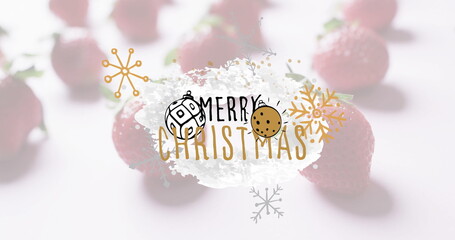 Displaying white brushstroke bearing Merry Christmas text on table with strawberries and ornaments