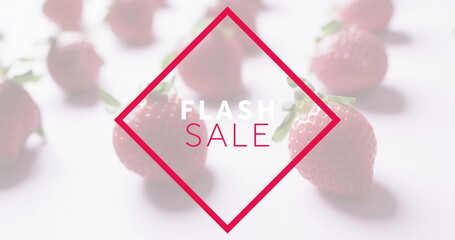 Displaying red diamond frame highlighting FLASH SALE on white tabletop, with ripe strawberries