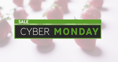Displaying green and black Cyber Monday sale banner over soft white surface, with red strawberries