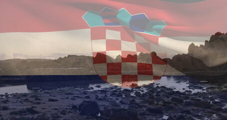 Displaying transparent checkerboard crest overlaying rocky shoreline with tide pools under pink sky