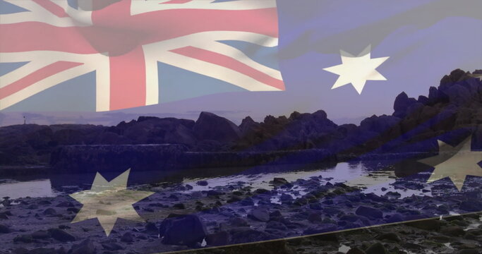 Overlaying faint Australian flag over rocky shoreline, with low tide pools and boulders