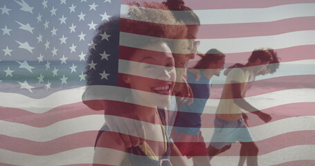 Walking friends in summer clothes laughing along shore, with ocean waves and American flag overlay