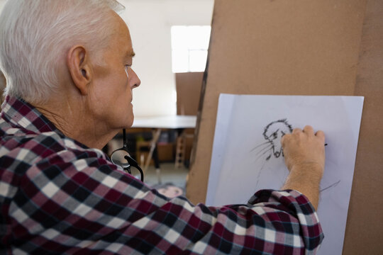 Drawing board displaying figure head outline being sketched in art studio with window light - Powered by Adobe