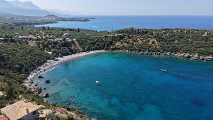 Obraz premium Aerial View of Secluded Beach Cove with Turquoise Waters in Mani Peninsula, Peloponnese, Greece, Delfinia beach