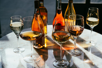 Different types of wine in glasses - red, white, rose and amber. Wine tasting in a bar or restaurant.
