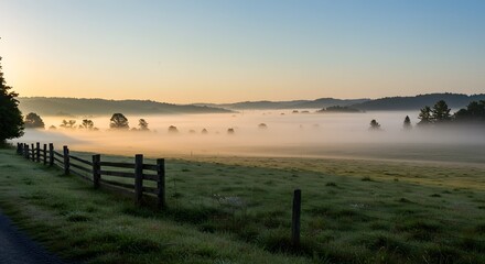 Obraz premium Scenic Misty Morning Landscape with Fence and Fog