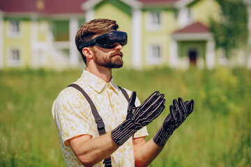 Man controlling a swarm of drones with smart gloves during an outdoor tech demonstration in clear daylight. Realistic clothing and expressions highlight advanced wearable technology background