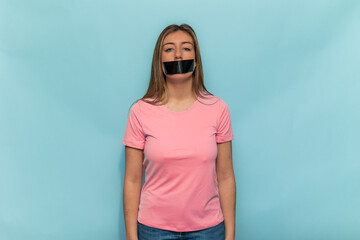 Woman wearing pink t-shirt promoting Breast Cancer Awareness with taped mouth