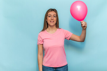 Woman wearing pink t-shirt holding pink balloon for Breast Cancer Awareness