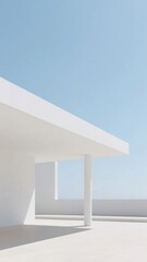 Modern minimalist architecture with white columns and a clear blue sky