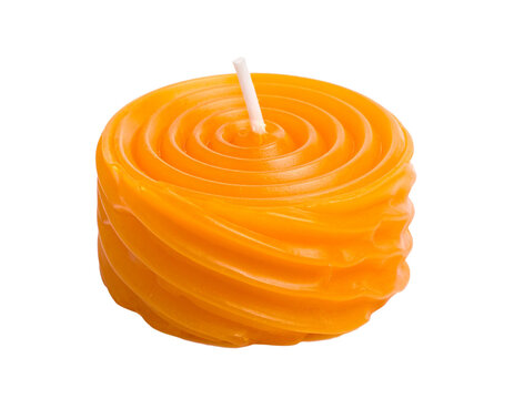 A unique orange spiral-shaped candle, an artistic and decorative item, isolated on white.