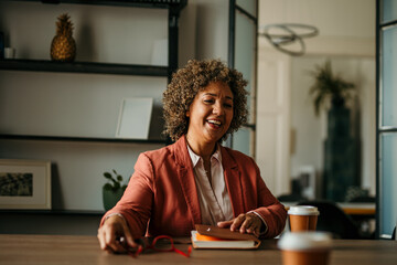 Happy senior businesswoman smiling during business meeting in office