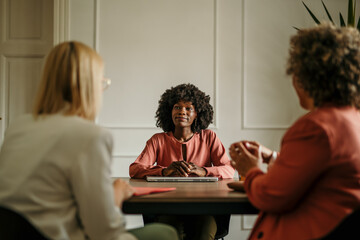 Confident black woman attending job interview with two recruiters