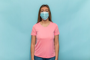 Woman wearing pink t-shirt and surgical mask for Breast Cancer Day during pandemic