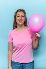 vertical Woman wearing pink t-shirt holding pink balloon for Breast Cancer Awareness