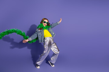 Adorable Stylish child dancing in fashionable outfit with vibrant background