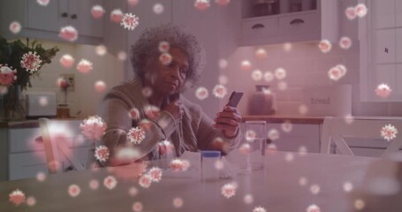 Senior woman tapping smartphone screen and taking pill with animated particles tracking health data - Powered by Adobe