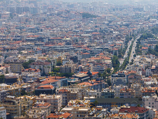 Aerial view of Alanya city in Turkey. Dense urban buildings, Mediterranean coastline, green hills...