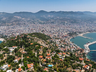 Drone view of Alanya city, Turkey. Coastline, Mediterranean Sea, harbor, historic castle on the...