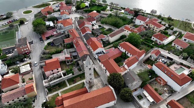 Historic coastal town Nin captured by drone in spring. Old town Nin with stone houses and Adriatic backdrop filmed from above, showing heritage and coastal charm in springtime Croatia