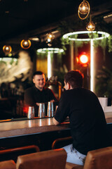 Two People Engaging in Conversation at a Modern Bar Setting