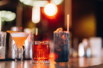 Selection of Colorful Cocktails on a Bar Counter With Warm Ambient Light
