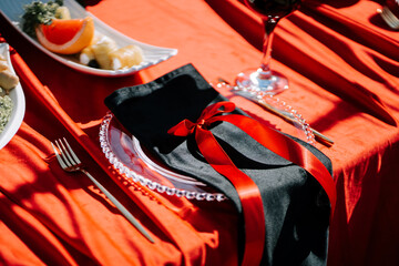 Elegant dining setup with red accents and stylish tableware for special occasion celebration