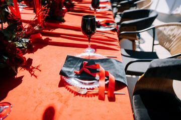 Elegant dining setup with red decor and fine tableware for a special occasion