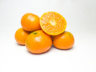 Fresh oranges with cut in half isolated on white background.