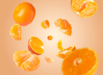 Juicy tangerines swirling in air against pastel orange background