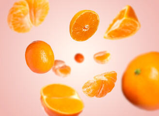 Juicy tangerines swirling in air against pink gradient background