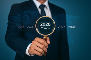 Businessman analyzing future business trends for 2026. Concept of strategic planning, forecasting, and market analysis.