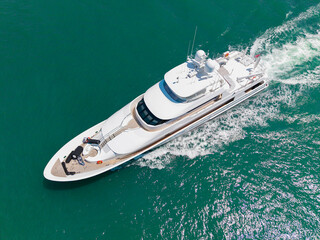 Fototapeta premium Luxury private yacht in sea. Motor yacht luxury vessel. Boat motor aerial. Vacation on summer. Aerial view motorboat. Yacht boat tour. Luxury boat yachting. Motorboat sailing at sea