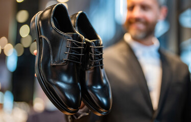 Classic leather shoes for formal look. Formal shoe. Leather footwear. Shop assistant in shoe store...