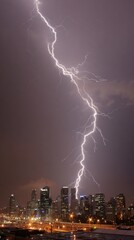 Powerful lightning bolt strikes city skyline at night