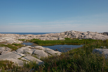 Vernal Pond surrounded by large granite boulders at Peggy's Cove in Nova scotia