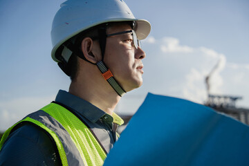 asian male engineer working in construction site for bridge