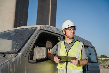asian male engineer working in construction site for bridge