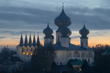 Domes and belfry of the ancient Tikhvin Dormition Monastery at October twilight. Leningrad region,...