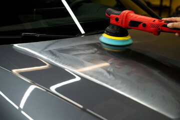Car paint correction and polishing. Polishing machine expertly removes paint swirls and oxidation...